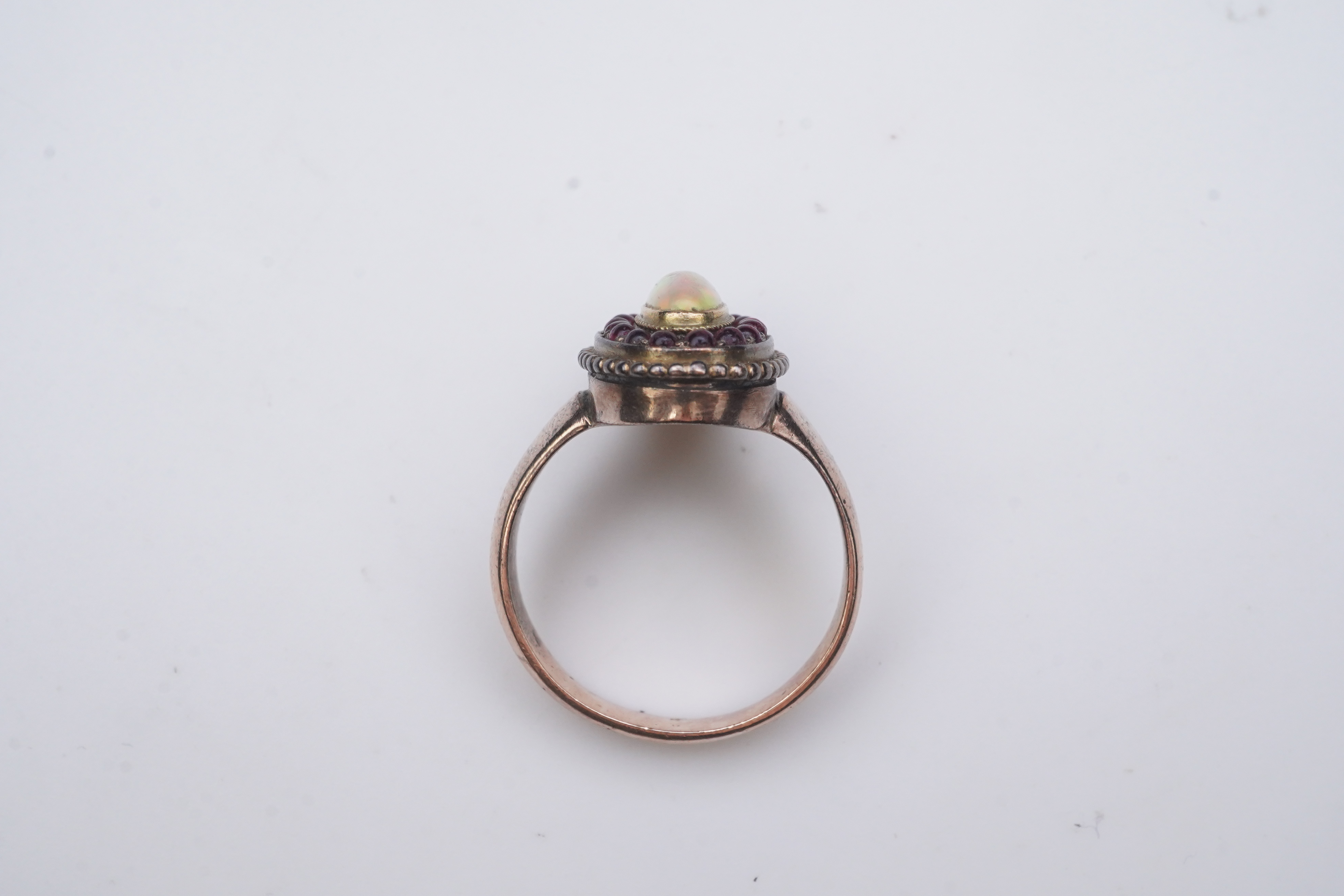 An opal and garnet ring